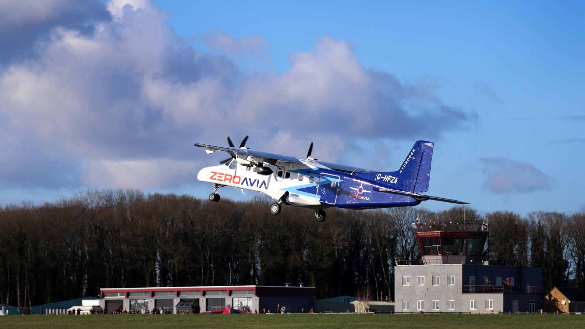 small 19-seater aircraft taking off from runway with regional airport in background