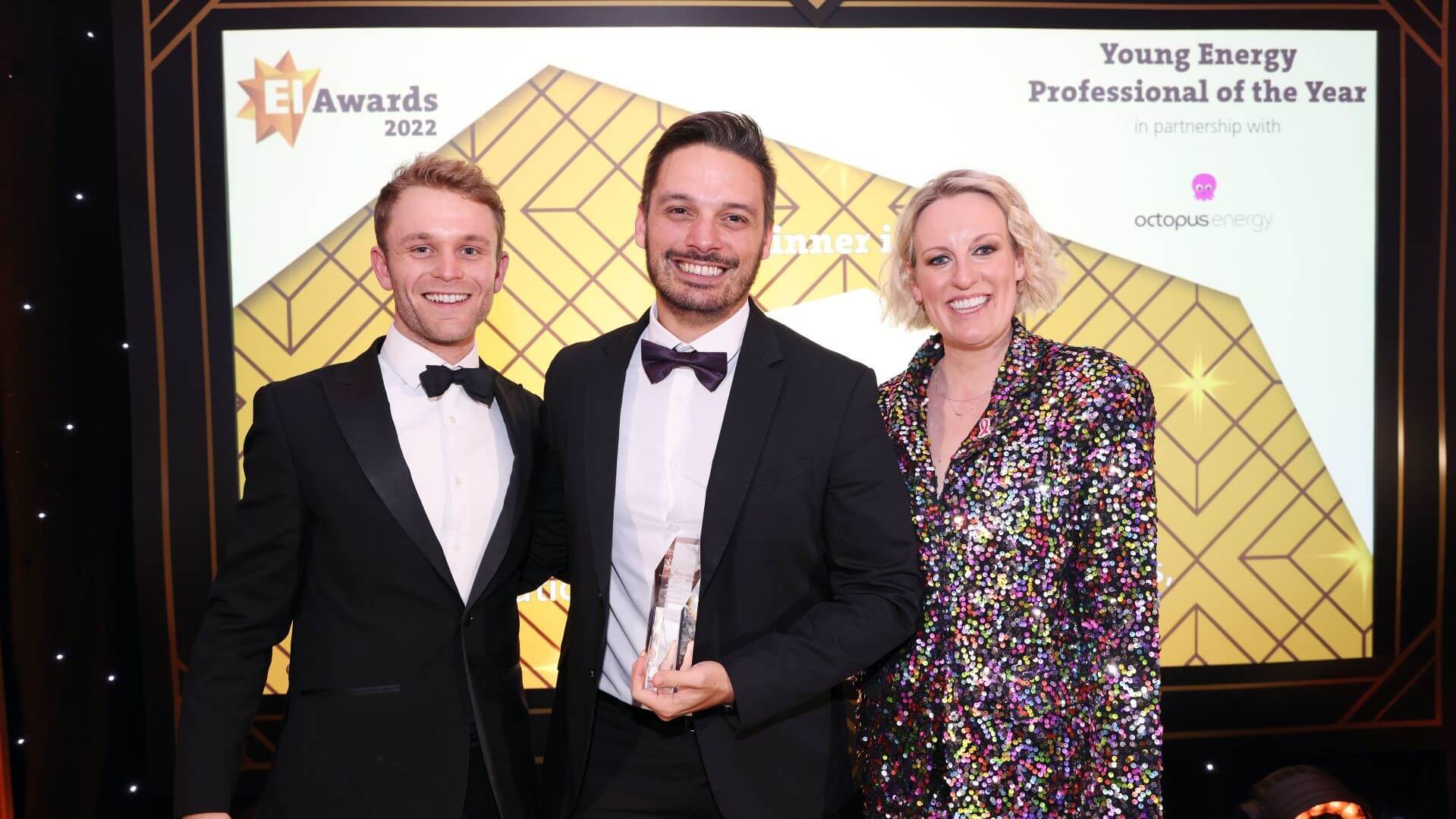 photo of Guilherme Castro and his award with two other people