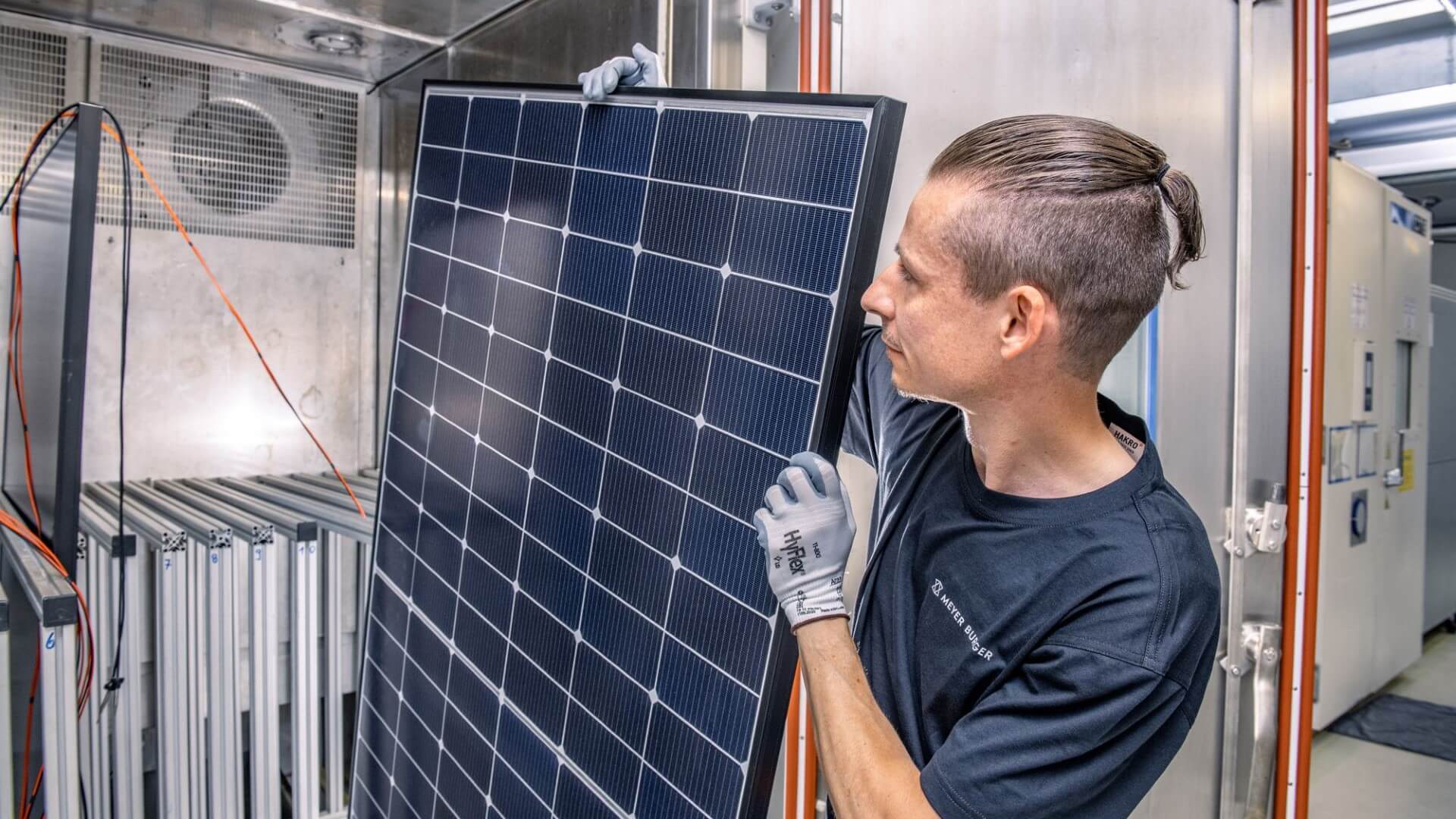close up of man holding solar panel