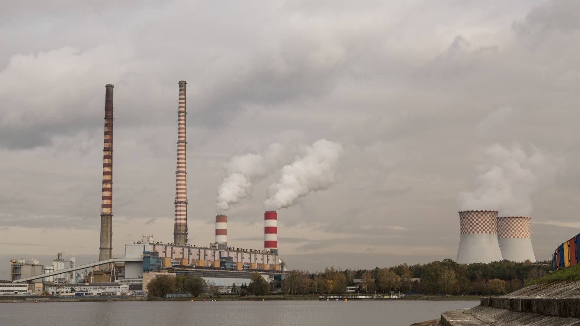 chimneys and coal power plant set against grey sky