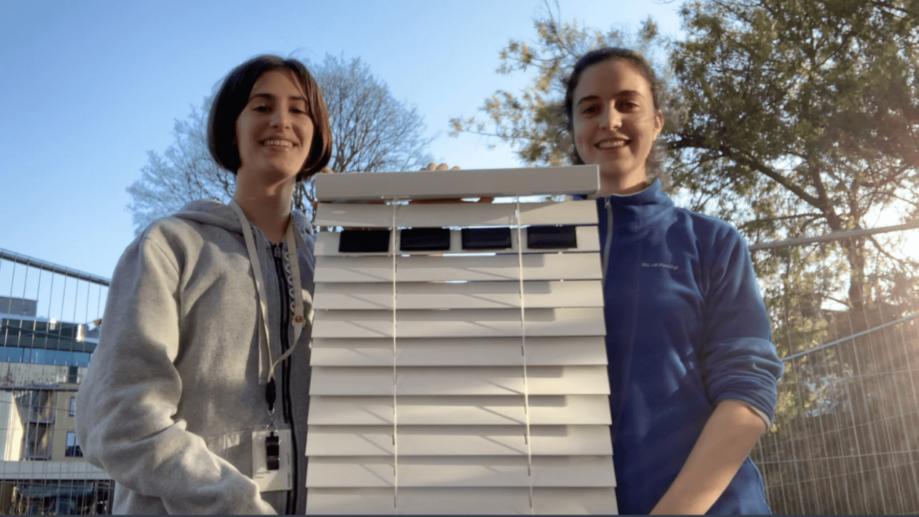 two schoolgirls holding up example of SolUp blinds