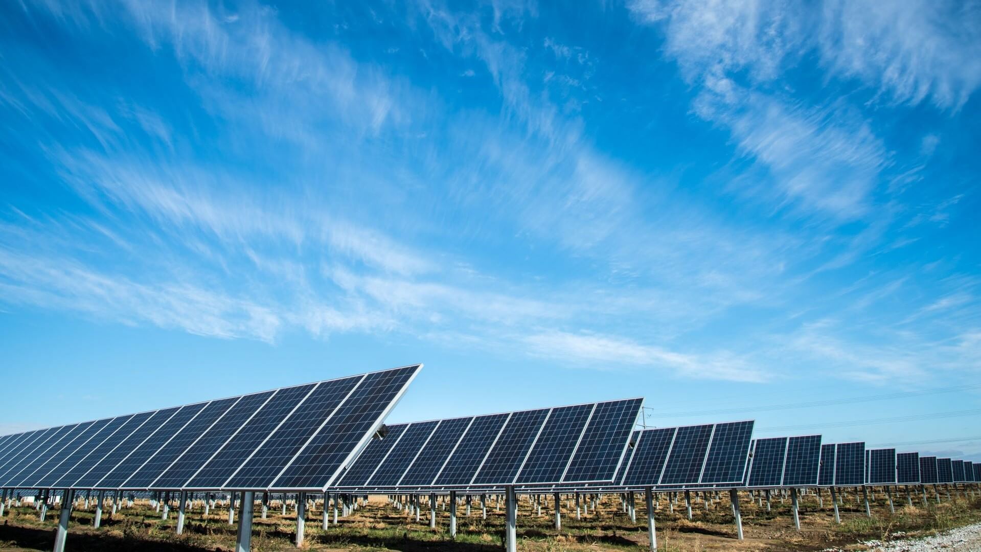 rows of solar panels set again bright blue sky