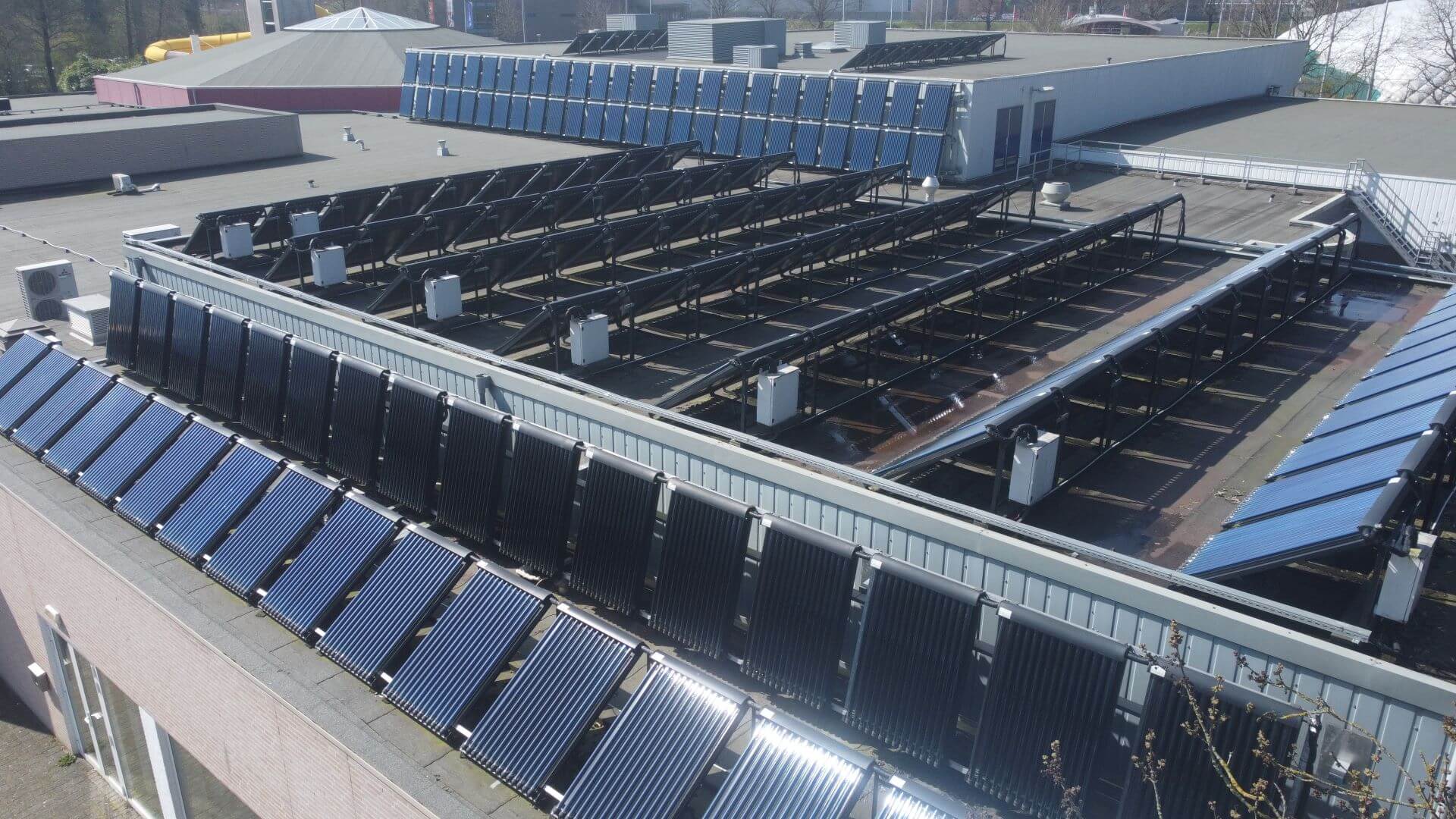 bank of solar panels on swimming pool roof 